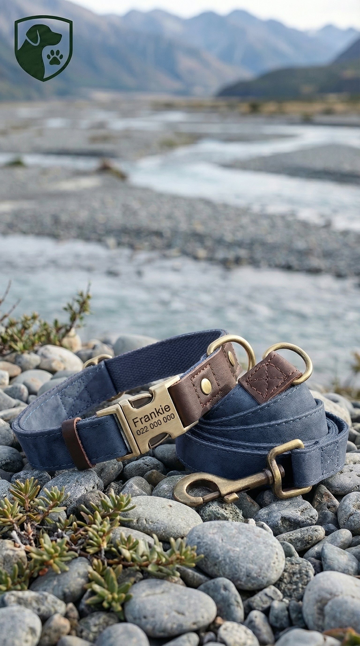 Two dog collars with brass hardware on a rocky surface with a mountainous background