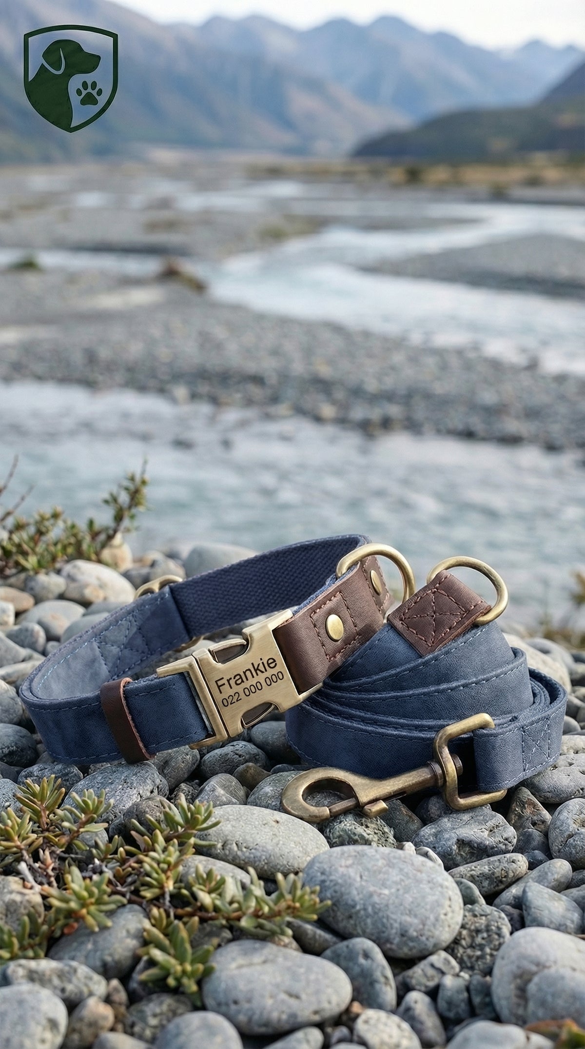 Two dog collars with brass hardware on a rocky surface with a mountainous background